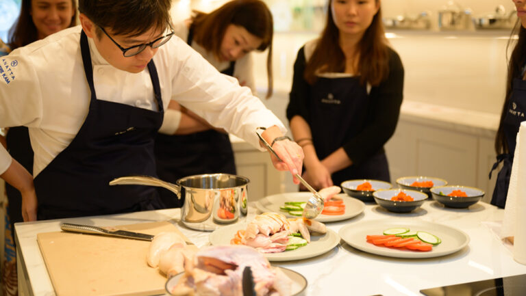 Tourists learning to cook Singapore's famed local dish - Chicken Rice
